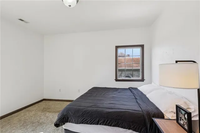 a spacious bedroom with a bed and cabinets