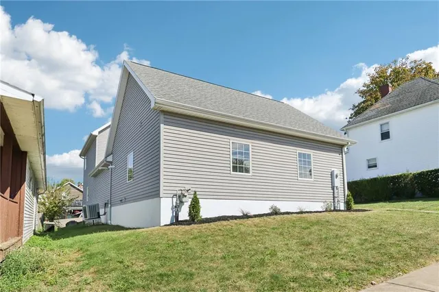 a backyard of a house with table and chairs