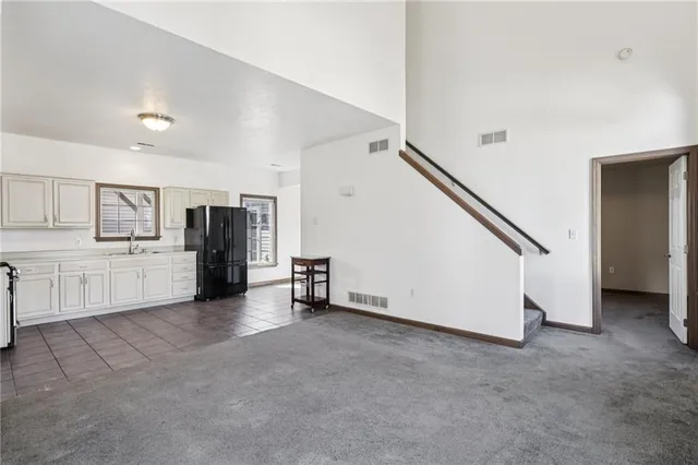 a kitchen with stainless steel appliances granite countertop a refrigerator and a stove top oven