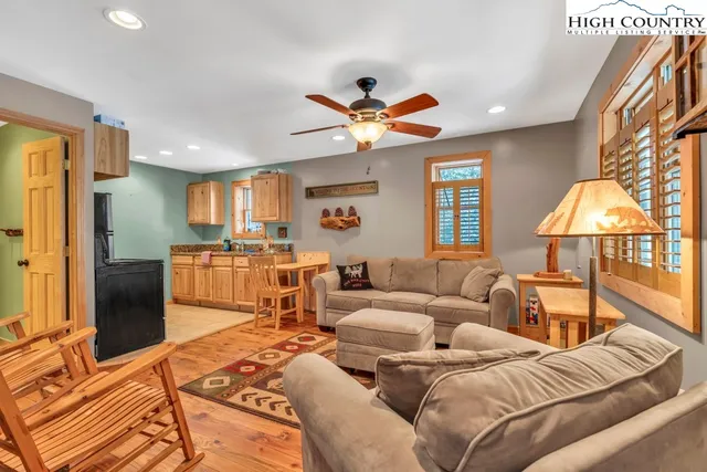 a living room with furniture a lamp and a flat screen tv