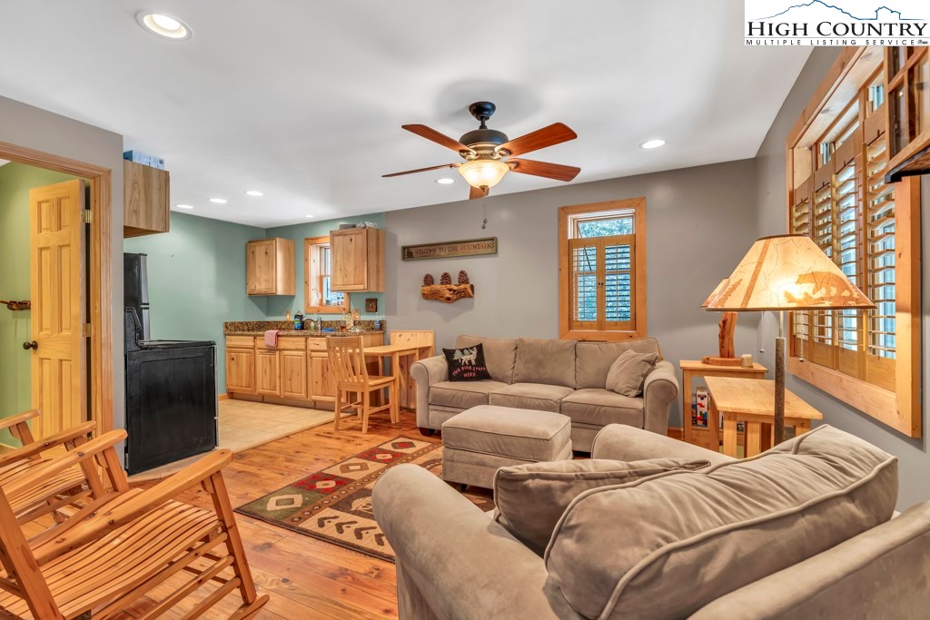 a living room with furniture a lamp and a flat screen tv