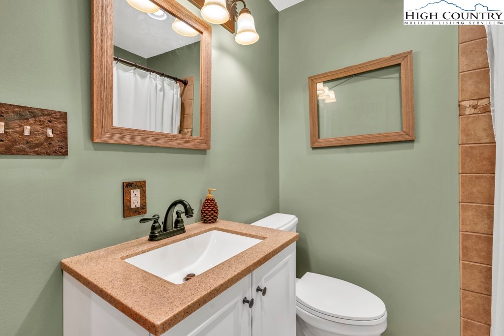 5171 Edgemont Road Collettsville, NC 28611 - Photo 11 of 21 a bathroom with a toilet a sink and mirror