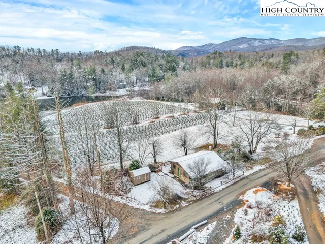 a view of a balcony with furniture and a yard