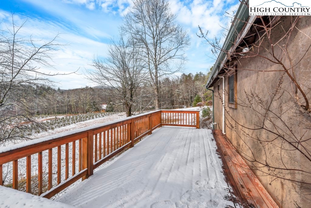 5171 Edgemont Road Collettsville, NC 28611 - Photo 19 of 21 a balcony with wooden floor and trees in the background