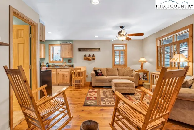 a living room with furniture fireplace and a large window