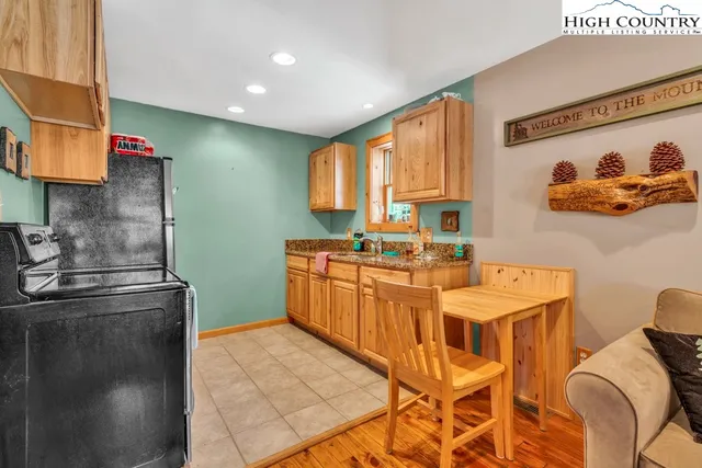 a kitchen with stainless steel appliances granite countertop a sink a stove and a refrigerator