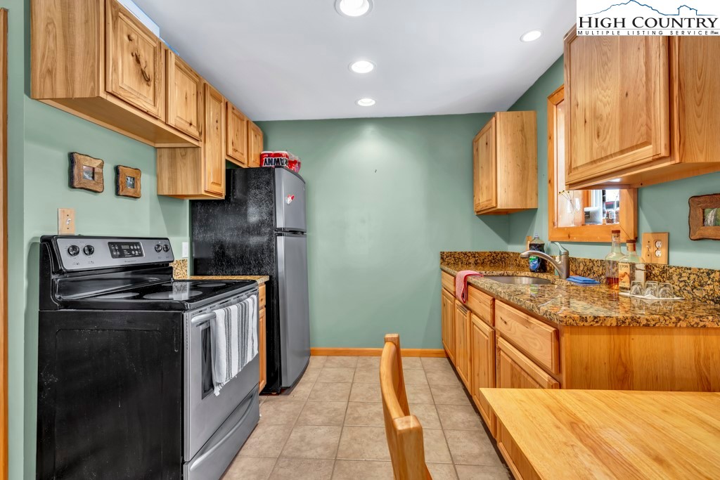 5171 Edgemont Road Collettsville, NC 28611 - Photo 8 of 21 a kitchen with stainless steel appliances granite countertop a stove a sink and a refrigerator