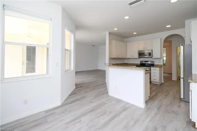 a kitchen with stainless steel appliances granite countertop a stove top oven and sink