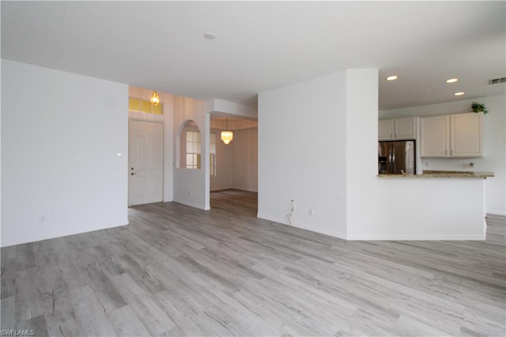 3927 Aurora Court Naples, FL 34116 - Photo 14 of 26 Unfurnished living room with light wood-type flooring and recessed lighting