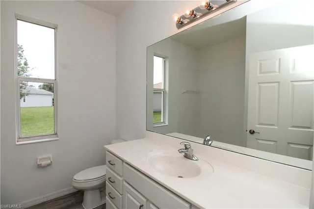 a bathroom with a sink toilet and vanity
