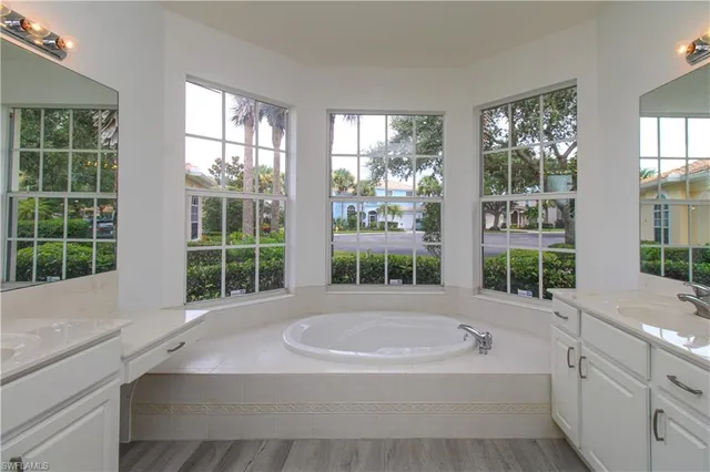 a bath tub sitting in a bathroom next to a window