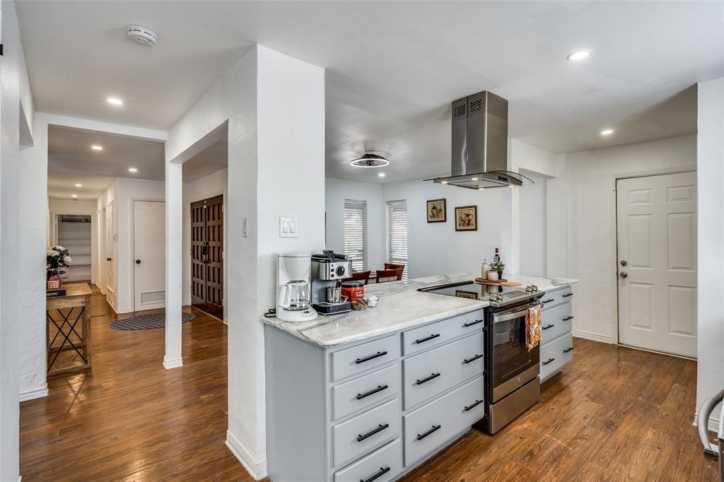 15642 Overmead Circle Dallas, TX 75248 - Photo 6 of 24 a kitchen that has a lot of cabinets in it and wooden floors