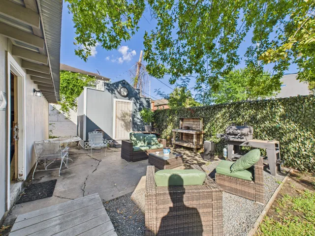 a view of a brick building next to a yard