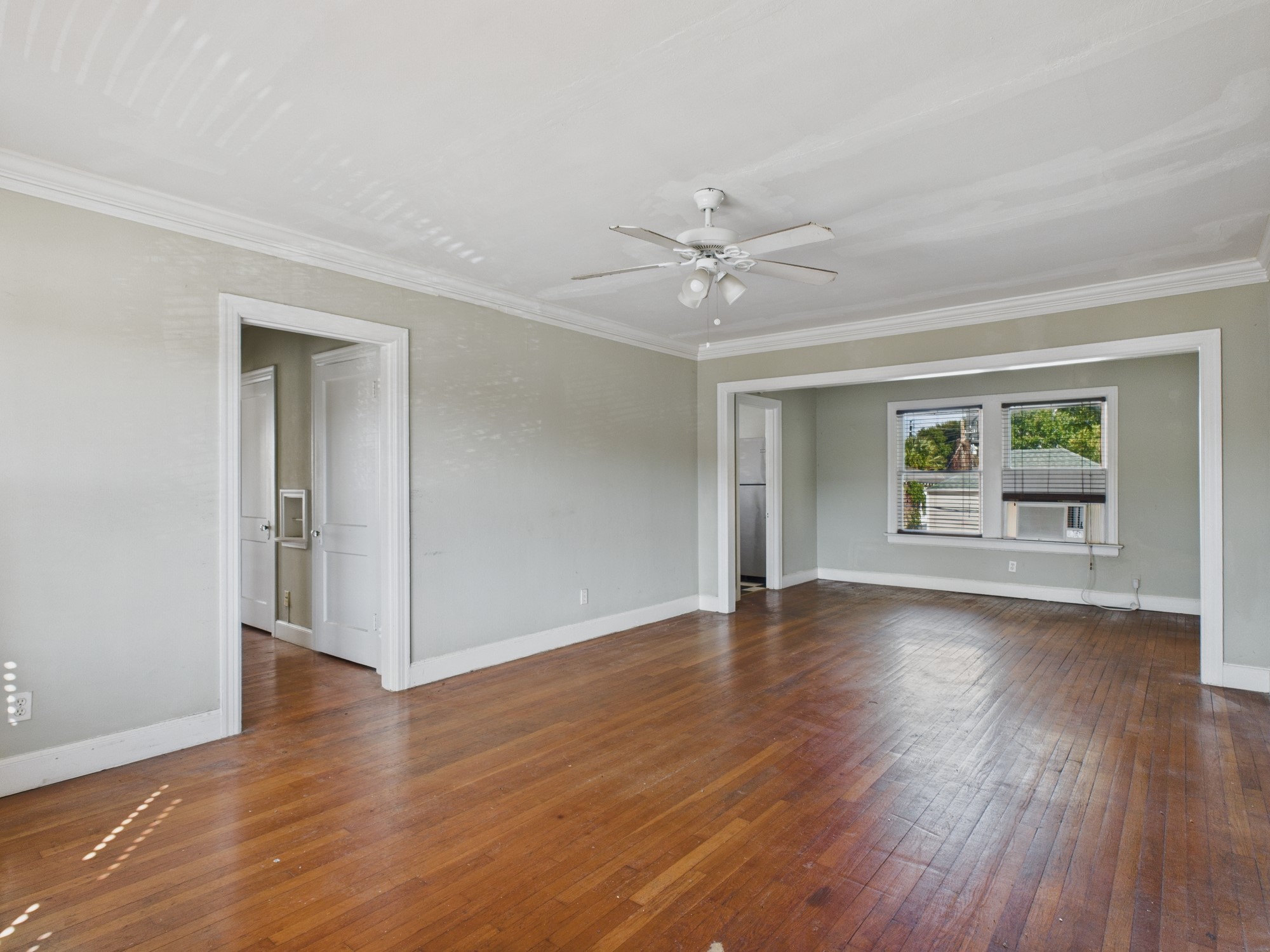 1920 Richmond Avenue, Unit 16 Houston, TX 77098 - Photo 2 of 18 a view of an empty room with window and wooden floor