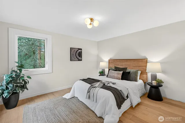 a bedroom with a bed and a potted plant