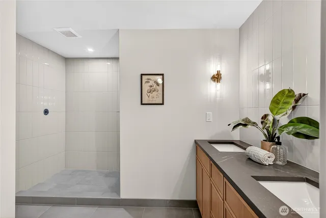 a bathroom with a sink a potted plant and a window