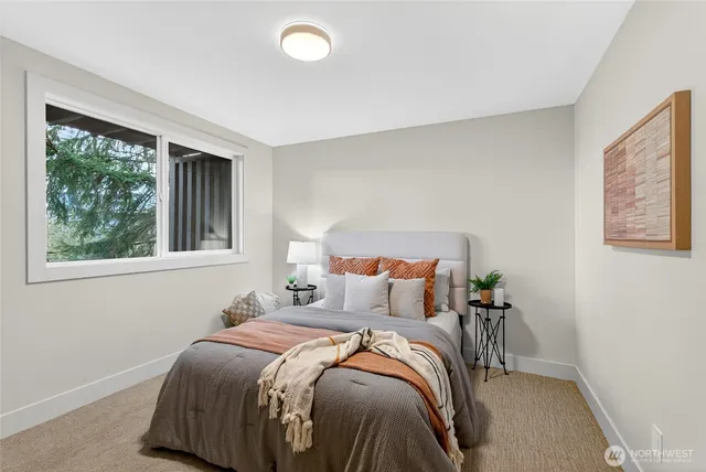 a bedroom with a bed and windows