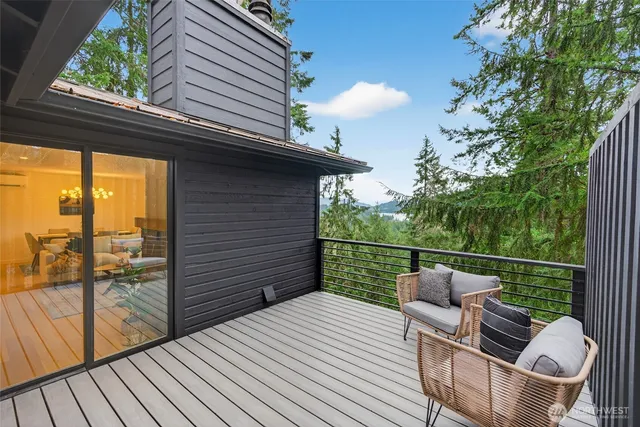 a view of a balcony with two chairs and a potted plant