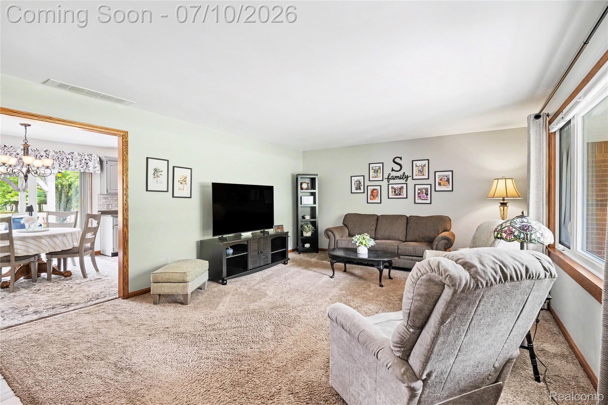 2180 Hurst Road St. Clair, MI 48079 - Photo 7 of 39 Carpeted living area featuring light green walls, a white ceiling, and wood-trim windows