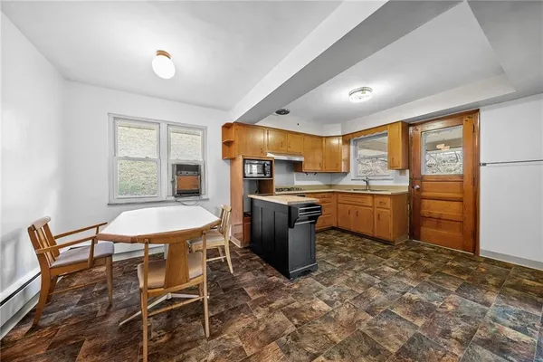 a kitchen with cabinets and chairs