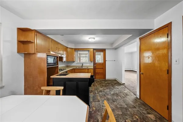 a view of a dining room with furniture and a window