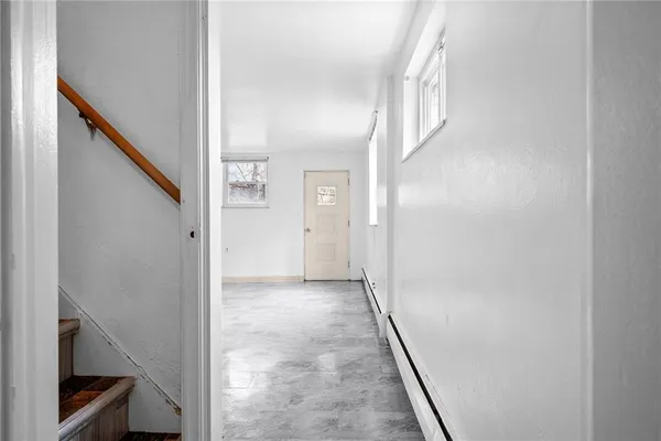 an empty room with a empty space and windows