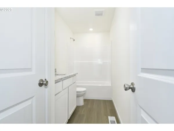 a bathroom with a sink a toilet a shower and a mirror
