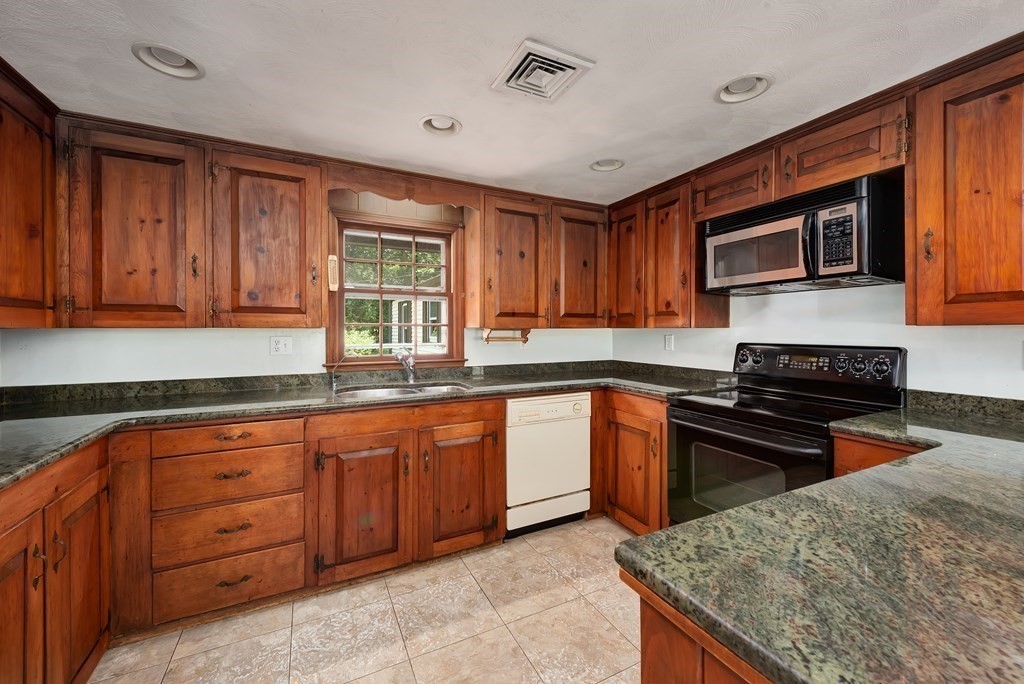 546 Ipswich Road Boxford, MA 01921 - Photo 2 of 27 a kitchen with granite countertop wooden cabinets stainless steel appliances and a window