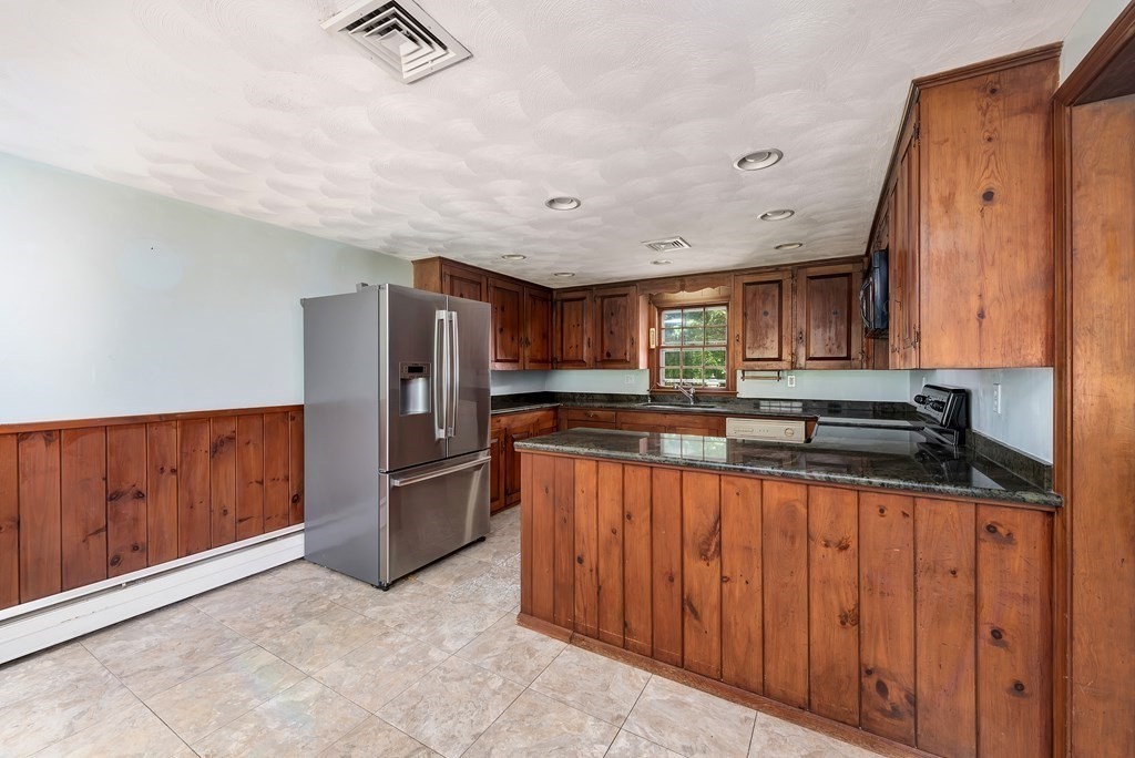 546 Ipswich Road Boxford, MA 01921 - Photo 4 of 27 a kitchen with stainless steel appliances granite countertop a refrigerator and a sink