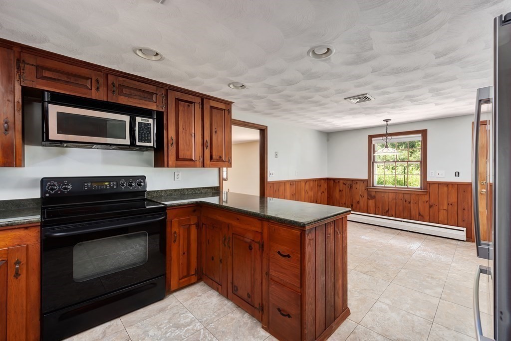 546 Ipswich Road Boxford, MA 01921 - Photo 5 of 27 a kitchen with stainless steel appliances granite countertop wooden cabinets a stove top oven a sink and dishwasher