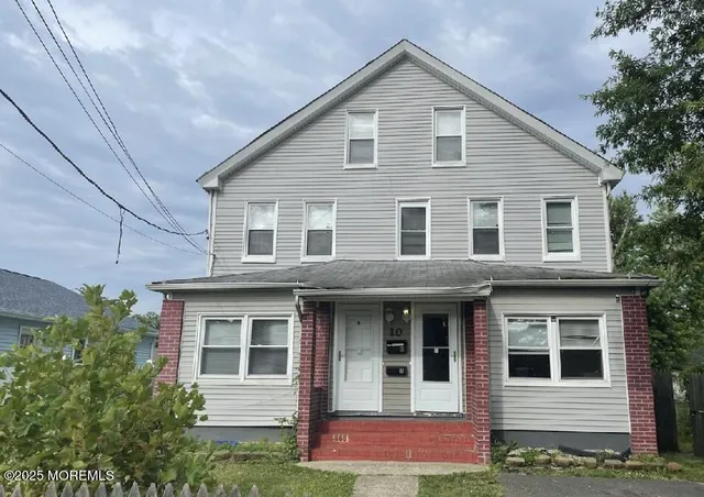 a view of a brick house with large windows