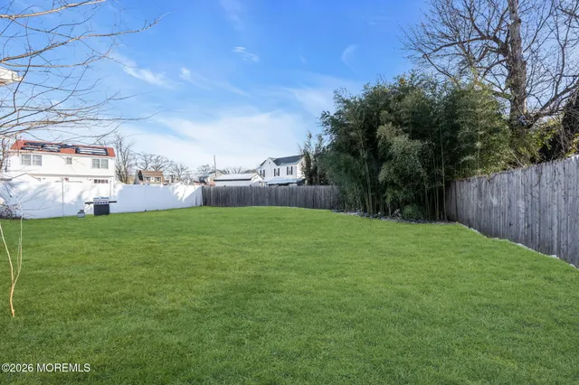 a view of yard with swimming pool and green space