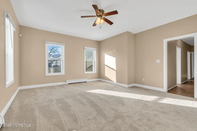 a view of a room with a window and a ceiling fan