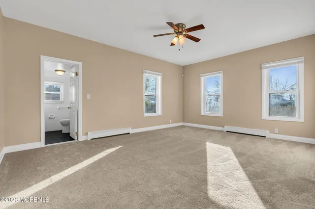 a view of an empty room with a bathroom