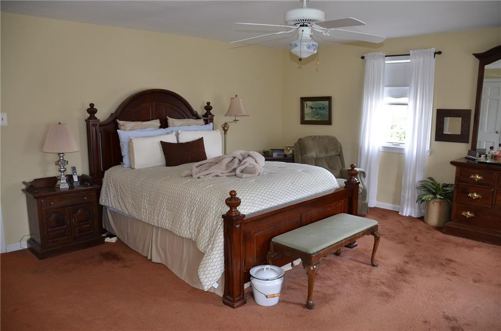 8187 Post Road Allison Park, PA 15101 - Photo 11 of 24 The expansive Master Bedroom features never exposed hardwood under the carpet, lots of natural light and a ceiling fan.