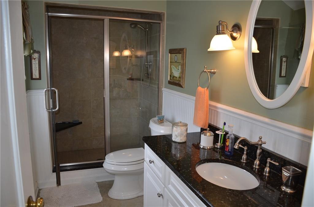 8187 Post Road Allison Park, PA 15101 - Photo 16 of 24 The Master Bath has been totally updated with wainscoting, tiled 5' shower w/seat, 5' vanity w/granite top and a ceramic tile floor.