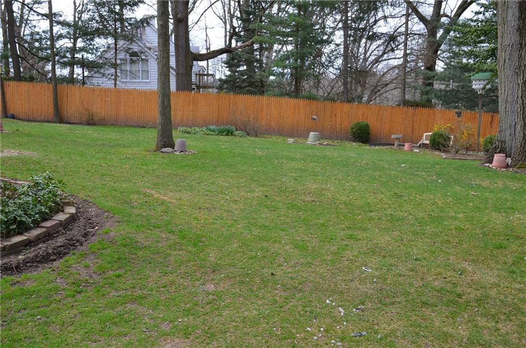 8187 Post Road Allison Park, PA 15101 - Photo 21 of 24 The expansive back yard is partially fenced and nicely landscaped with flowers galore.