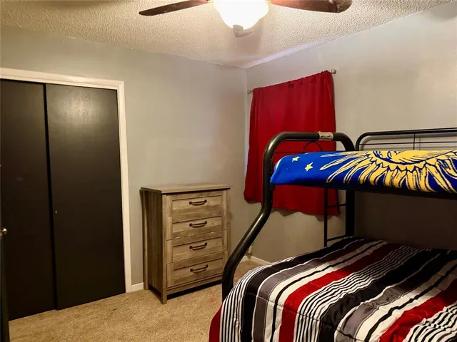 a bedroom with a bed and a closet