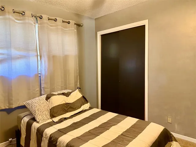 a bedroom with a bed and a mirror