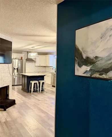 a view of kitchen with furniture and a fireplace