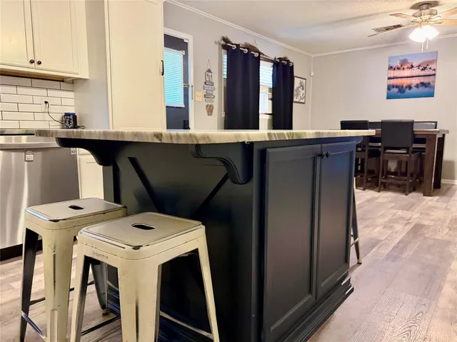 a kitchen with a table chairs and a refrigerator