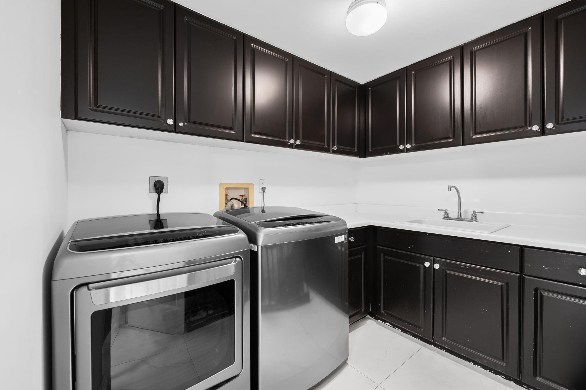456 East Boca Raton Road Boca Raton, FL 33432 - Photo 17 of 33 a kitchen with a sink cabinets and stainless steel appliances