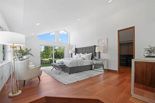 a bed room with a bed and large windows