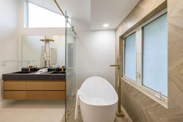 a spacious bathroom with a bathtub and shower