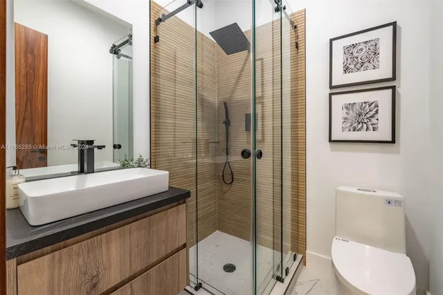 a bathroom with a shower and a glass door
