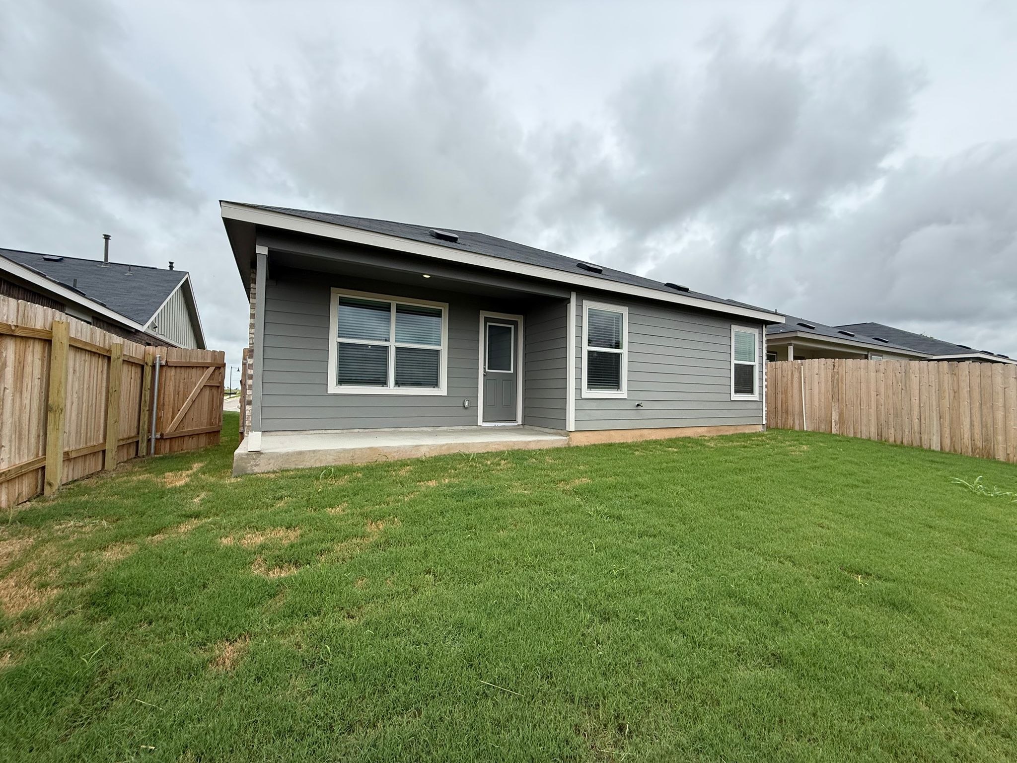 125 Sormonne Loop Kyle, TX 78640 - Photo 6 of 35 Rear view of property featuring a patio