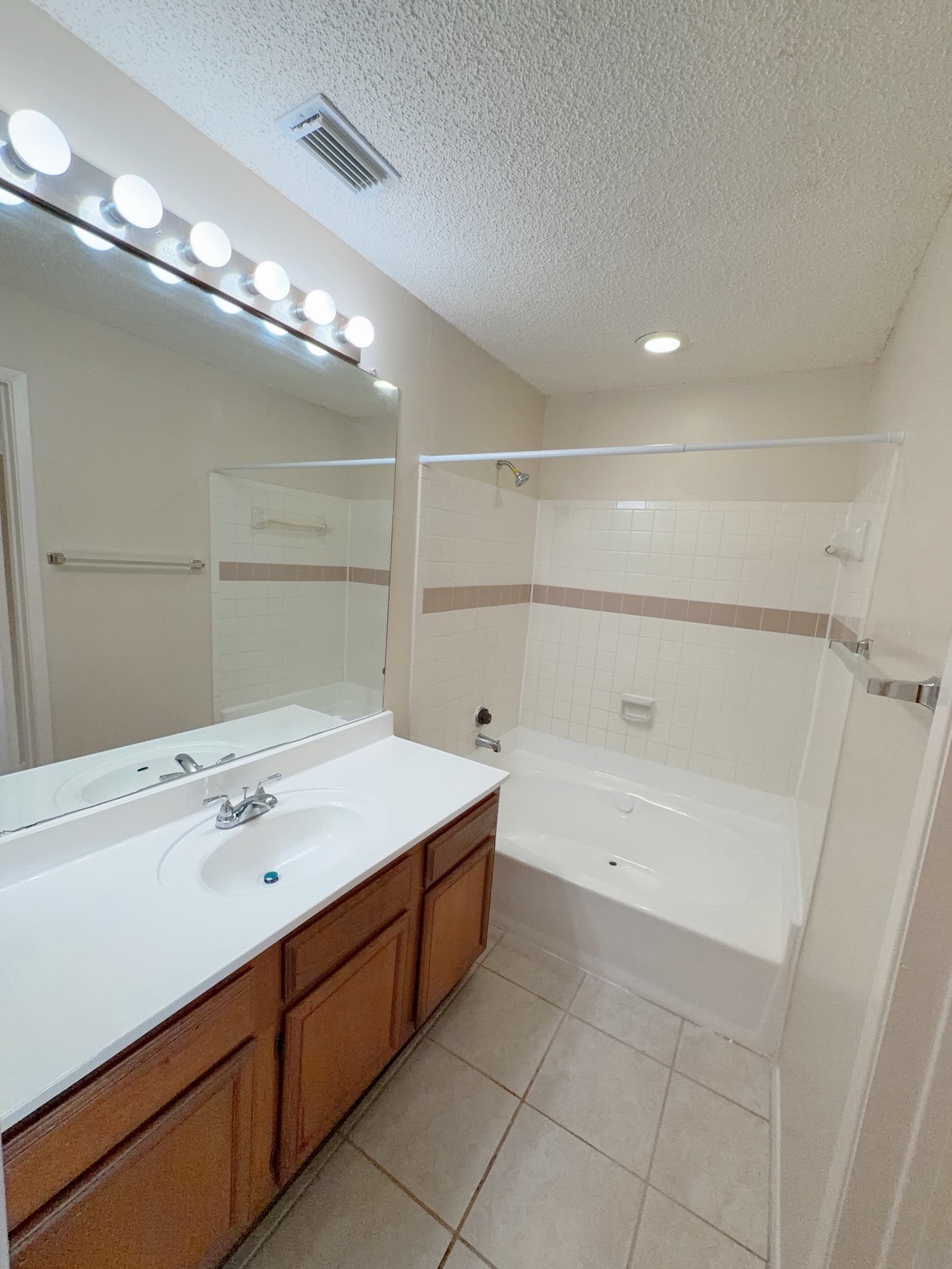 7900 Bissonnet Street, Unit C14 Houston, TX 77074 - Photo 11 of 14 a bathroom with a tub sink and mirror
