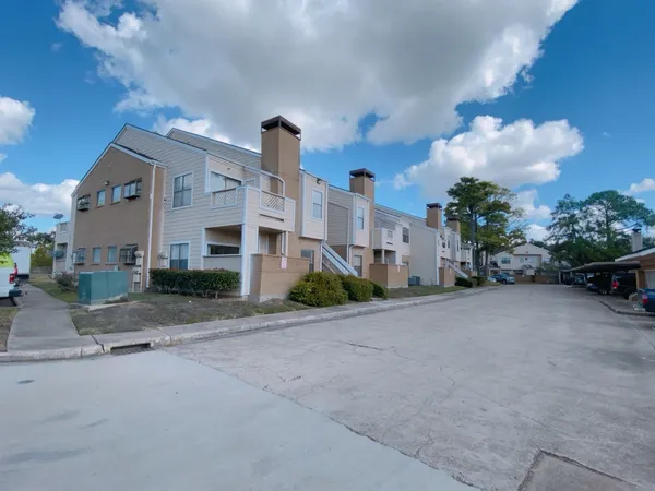 a front view of a house with a yard and a street view