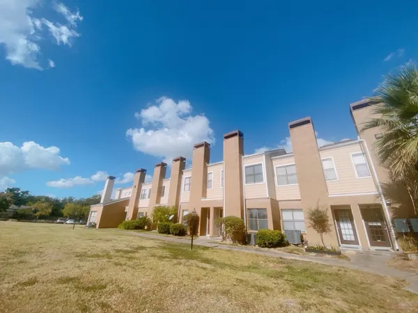 a front view of a building with a yard