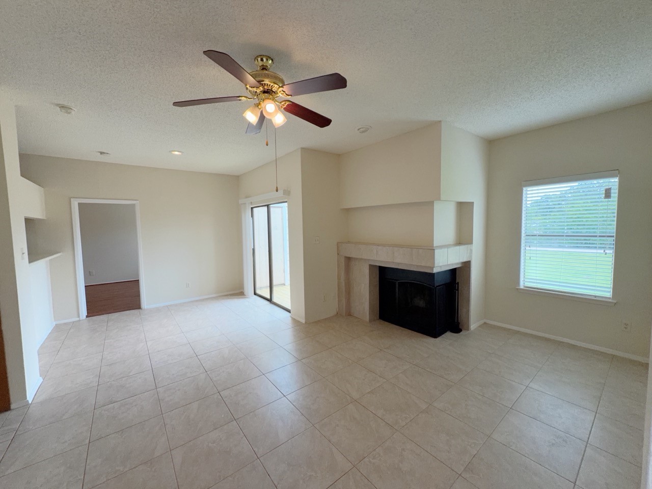 7900 Bissonnet Street, Unit C14 Houston, TX 77074 - Photo 2 of 14 a view of an empty room with window and chandelier fan